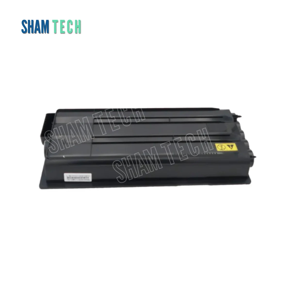 A black Kyocera laser toner cartridge is displayed horizontally without it's box against a plain white background. The rectangular plastic cartridge features structural ridges across its top surface, a small white tracking label on the lower-left side, and a yellow warning symbol on the right. The "SHAM TECH" logo appears in the top-left corner, and a large translucent "SHAM TECH" watermark is overlaid diagonally across the center of the image.